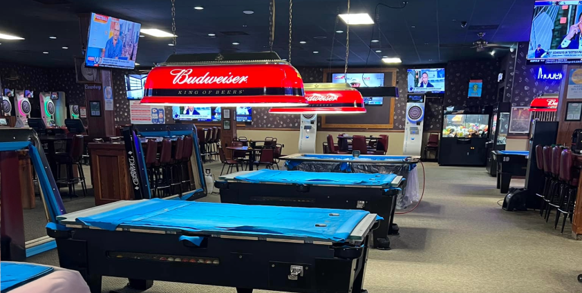 Inside bar with pool tables, televisions and dart boards
